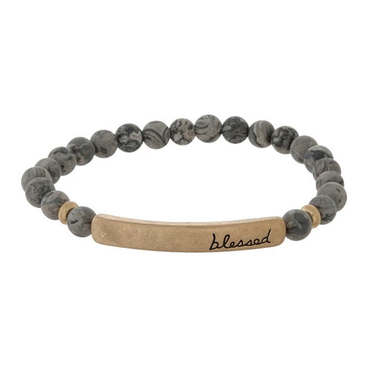 Beaded stretch bracelet with a bar focal, stamped with "blessed"